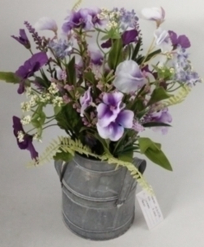 Lilac artificial meadow flowers by Bloomsbury. These stunning silk flowers come pre arranged in this lovely zinc churn and look hand picked from a meadow especially for you. For realistic artifical and silk flowers Bloomsbury is second to none.